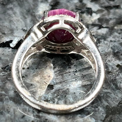 An oval cut natural ruby set in a sterling silver ring.