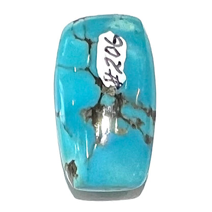 A loose, barrel cabochon cut blue turquoise stone from Burro Mountains, New Mexico.
