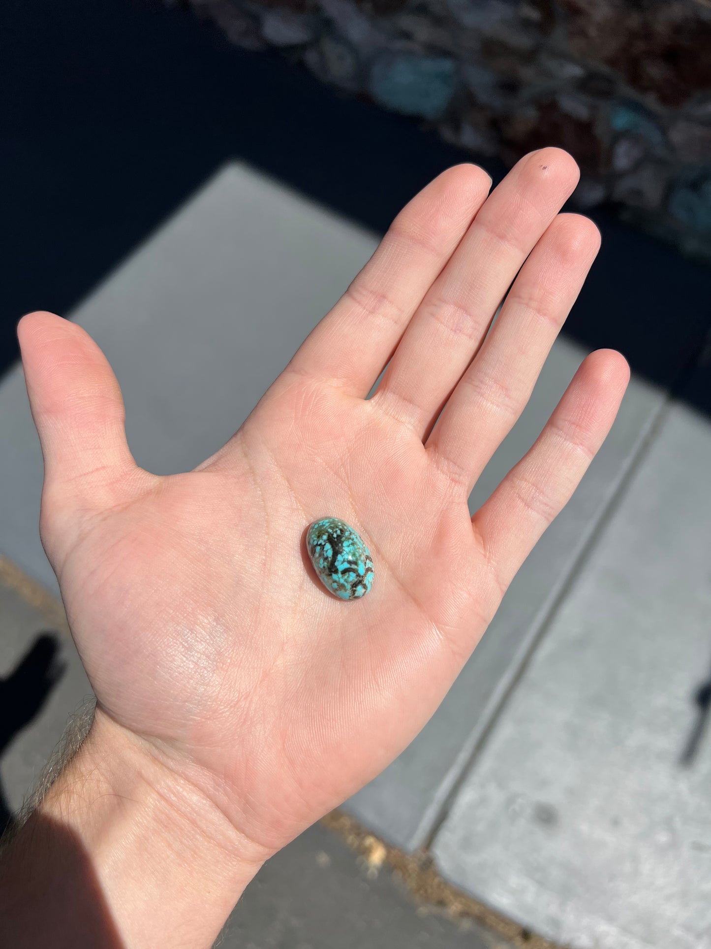 A loose, oval cabochon cut turquoise stone from Valley Blue Mine in Lander County, Nevada.