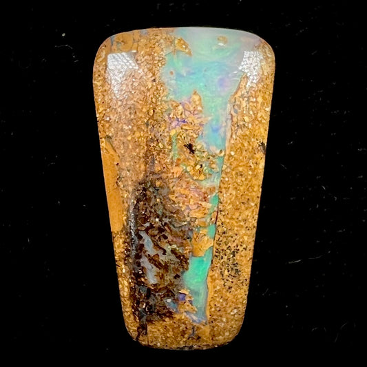 A polished, drilled pipe boulder opal bead.