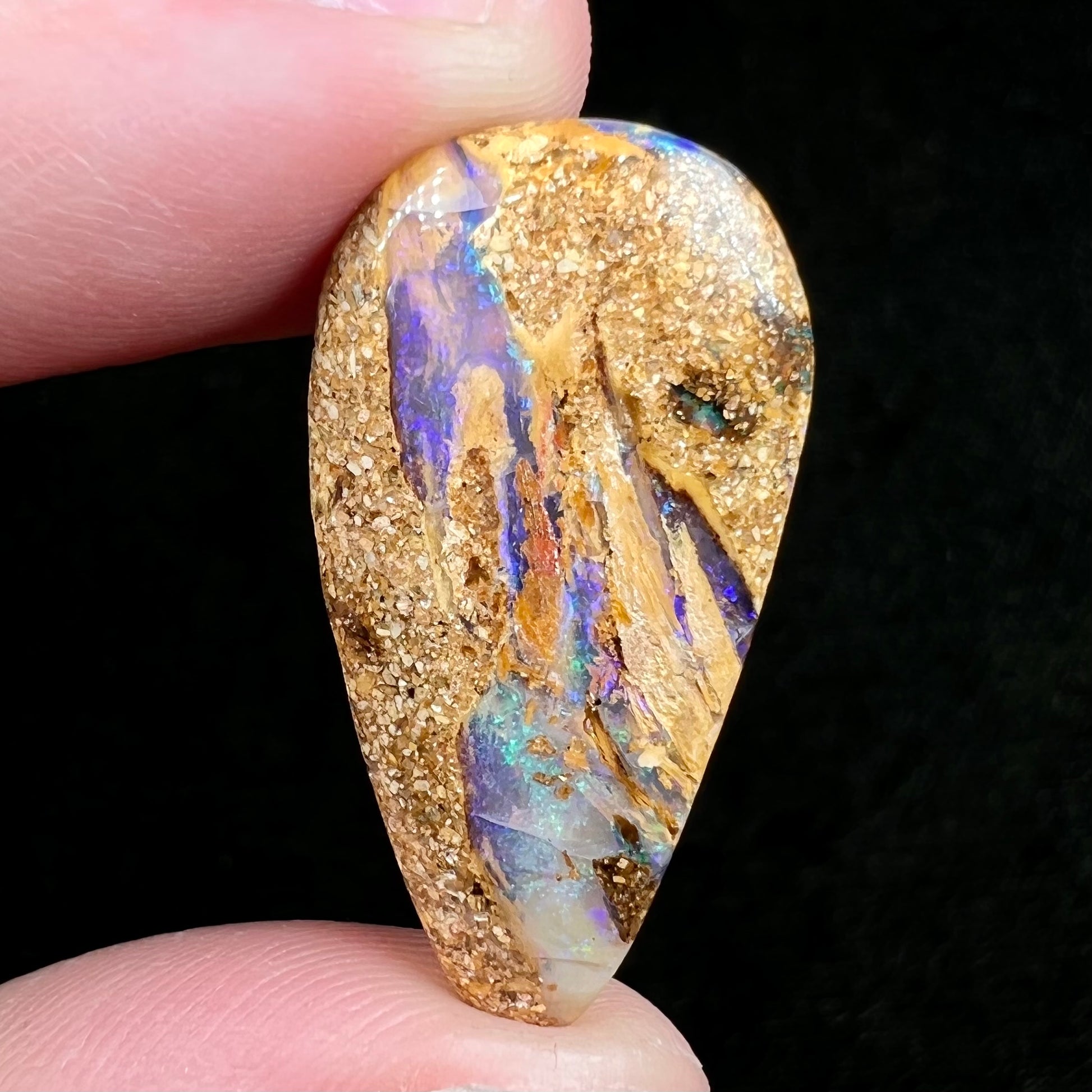 A polished, drilled pipe boulder opal bead.