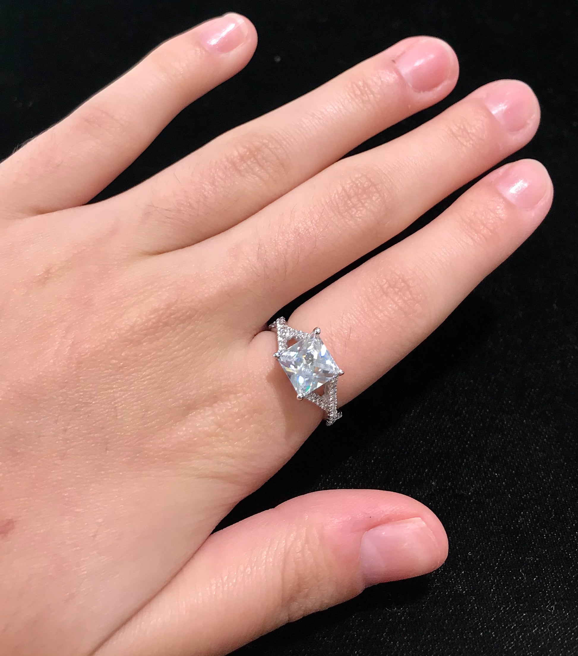 Women's cubic zirconia princess cut ring set in sterling silver with a twisted shank.