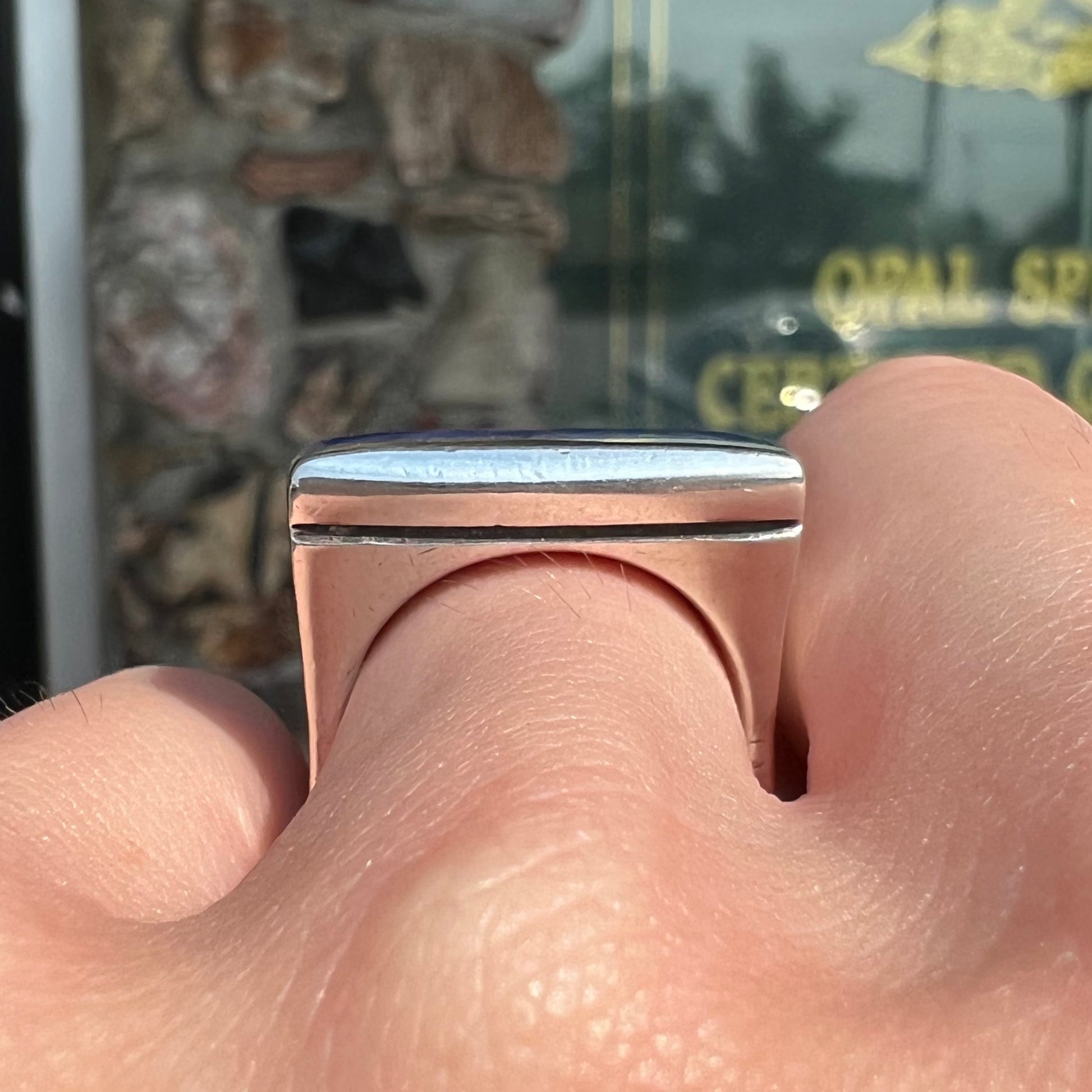 A sterling silver ring inlaid with a piece of lapis lazuli.  A small crack runs through the piece of lapis.