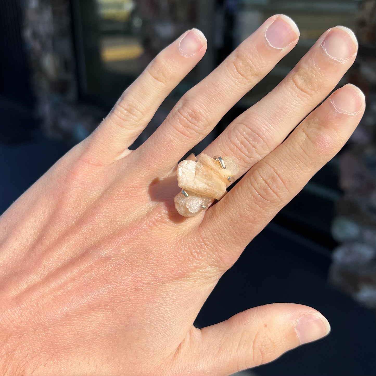 A sterling silver ring prong-set with a twinned moonstone crystal.