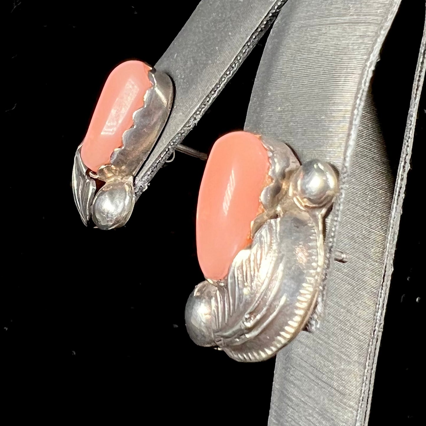 A pair of sterling silver coral earrings handmade by Zuni artists, Carmelita and Dan Simplicio.