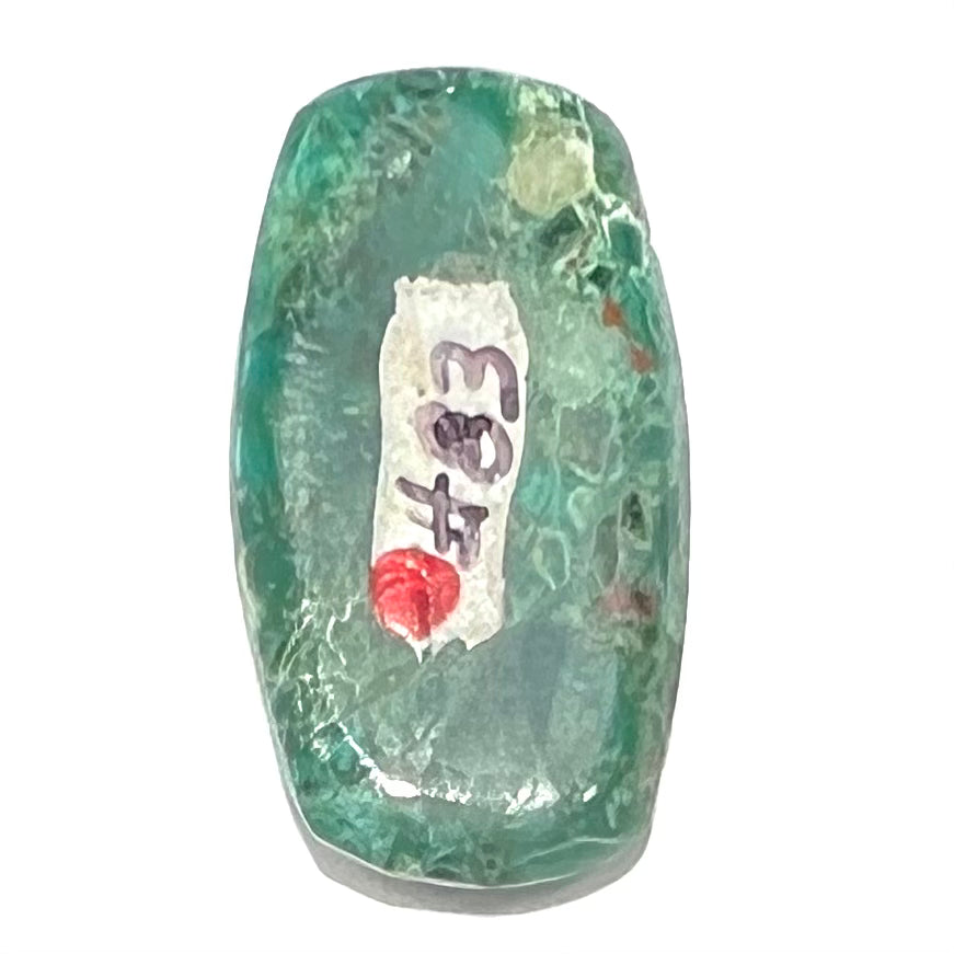 A loose, green, barrel cabochon shaped chrysocolla stone from Morenci, Arizona.