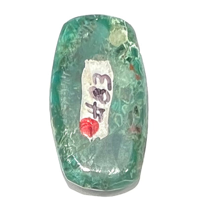 A loose, green, barrel cabochon shaped chrysocolla stone from Morenci, Arizona.