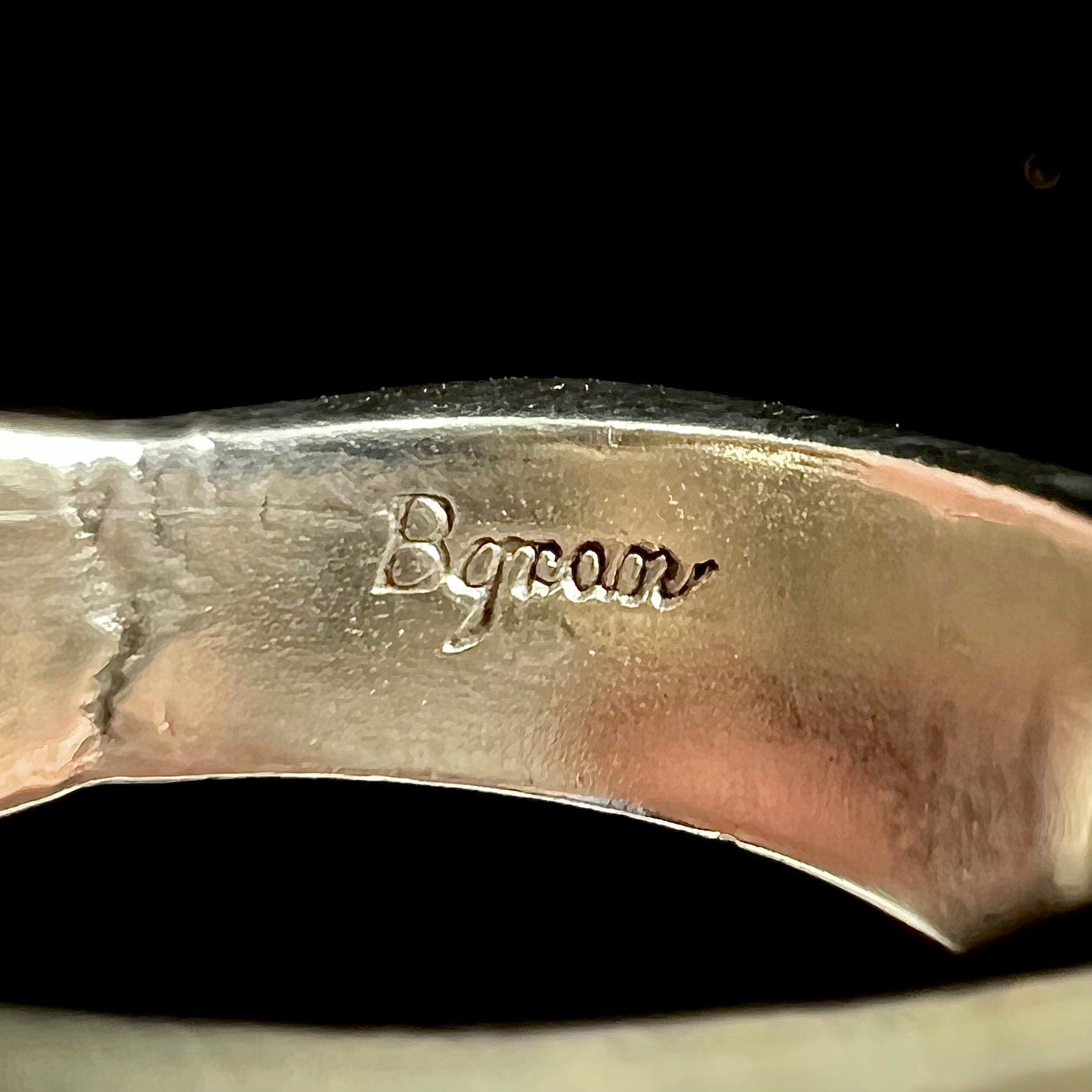 A sterling silver ring inlaid with a piece of lapis lazuli.  A small crack runs through the piece of lapis.