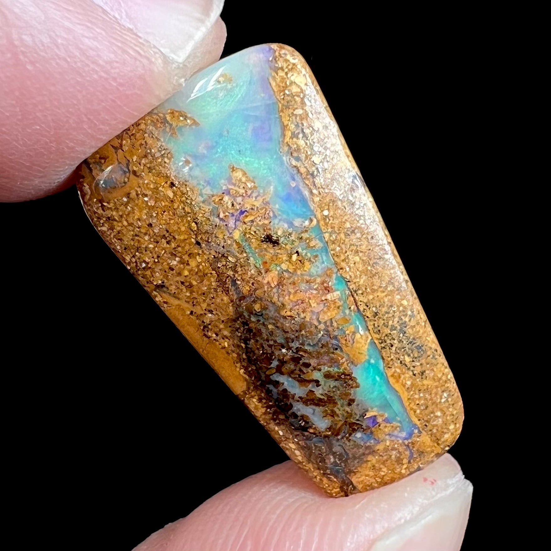 A polished, drilled pipe boulder opal bead.