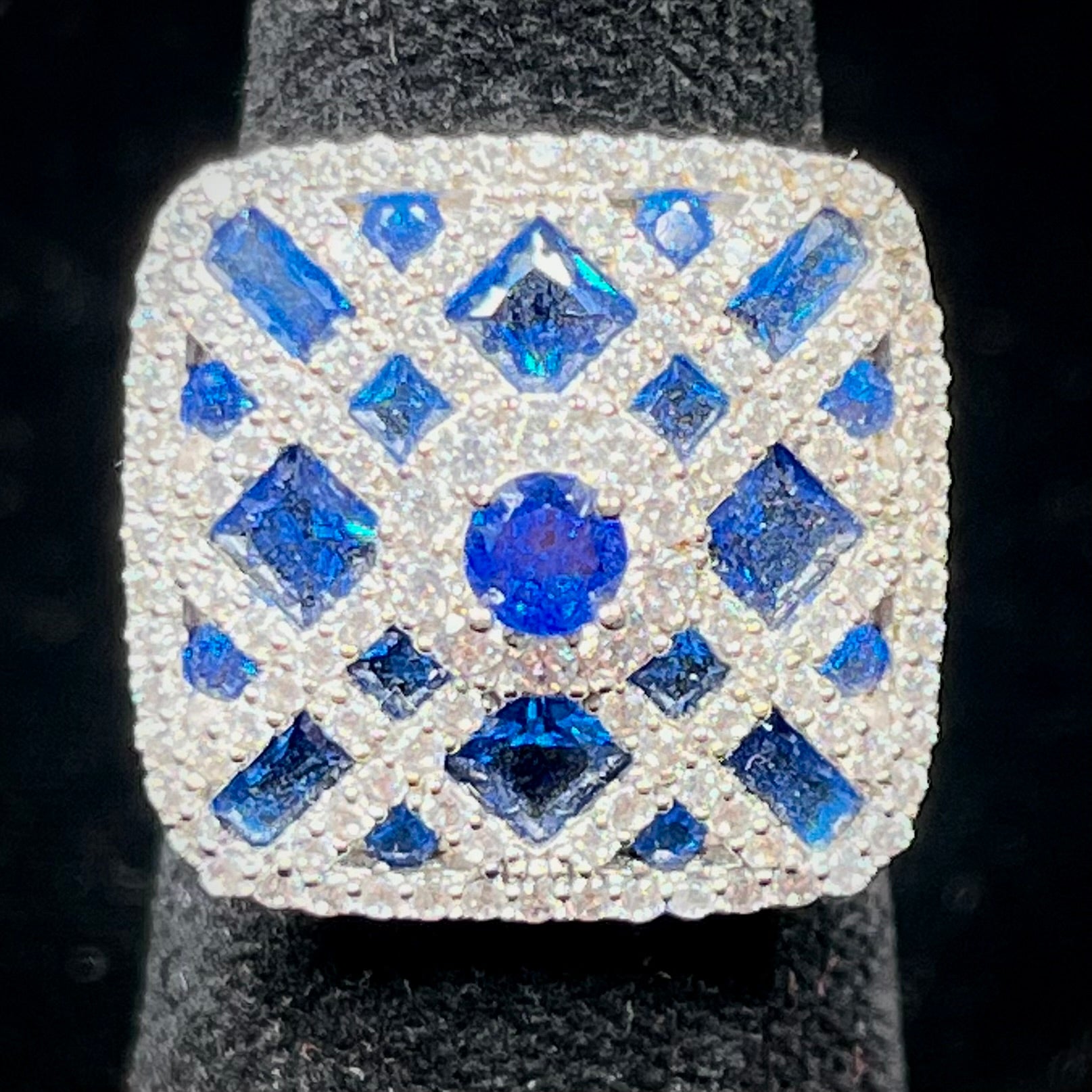 A sterling silver blue and white synthetic stone ring.  The ring strongly resembles a blueberry pie.