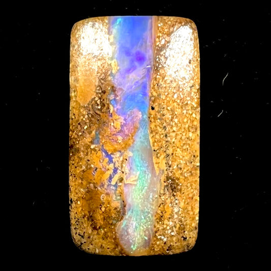 A polished, drilled pipe boulder opal bead.