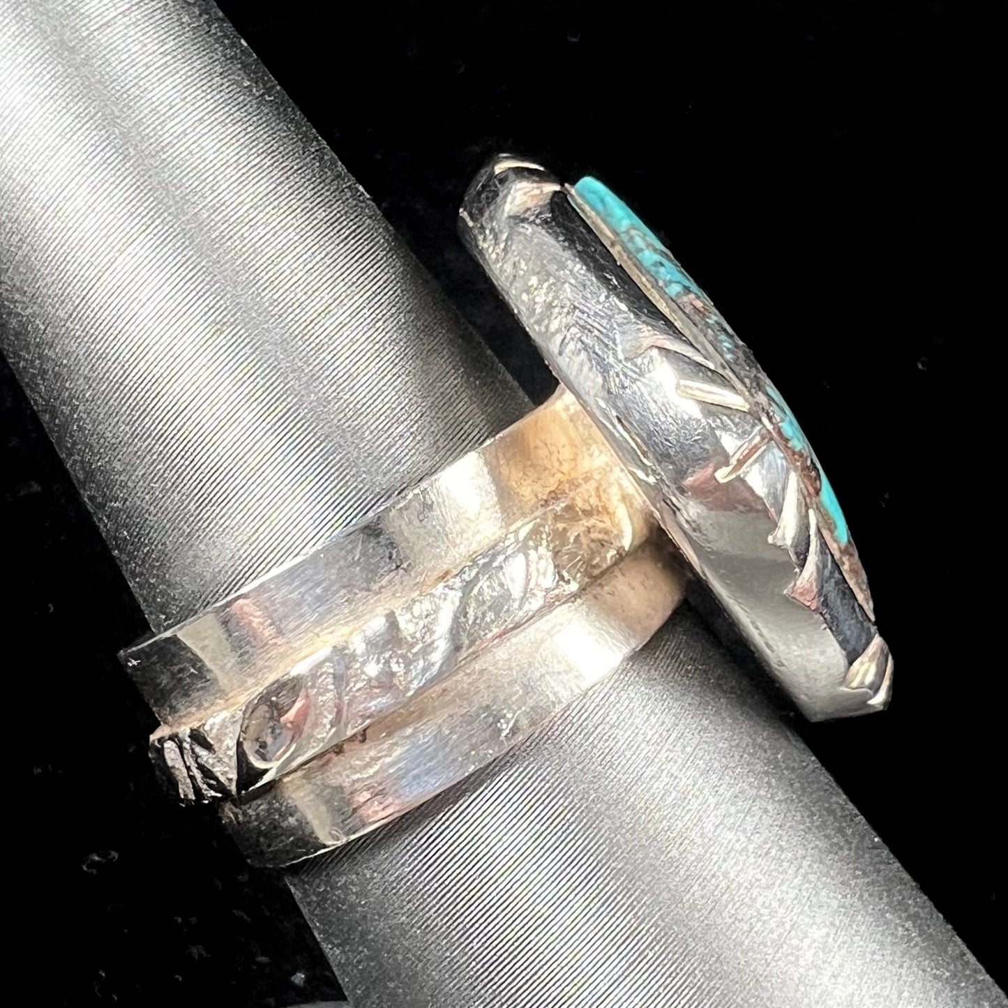 A handmade sterling silver, unisex, likely Navajo ring set with Tibetan turquoise.