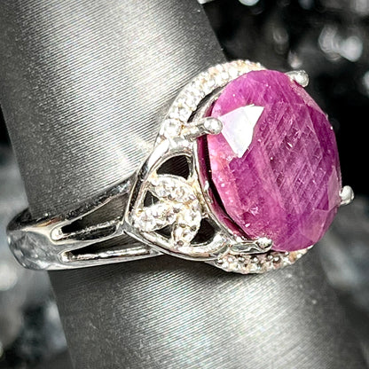An oval cut natural ruby set in a sterling silver ring.
