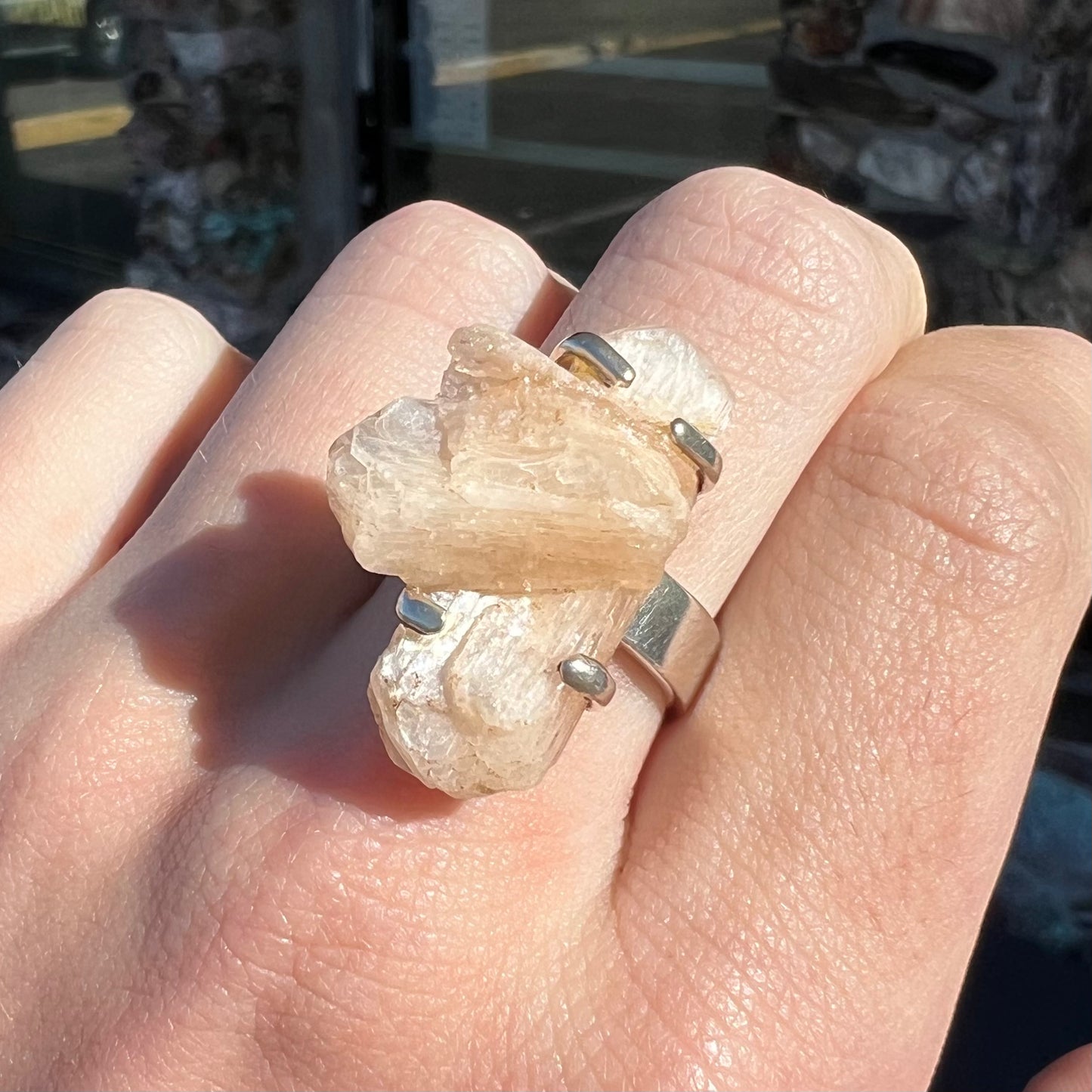 A sterling silver ring prong-set with a twinned moonstone crystal.