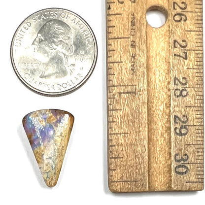 A polished, drilled pipe boulder opal bead.