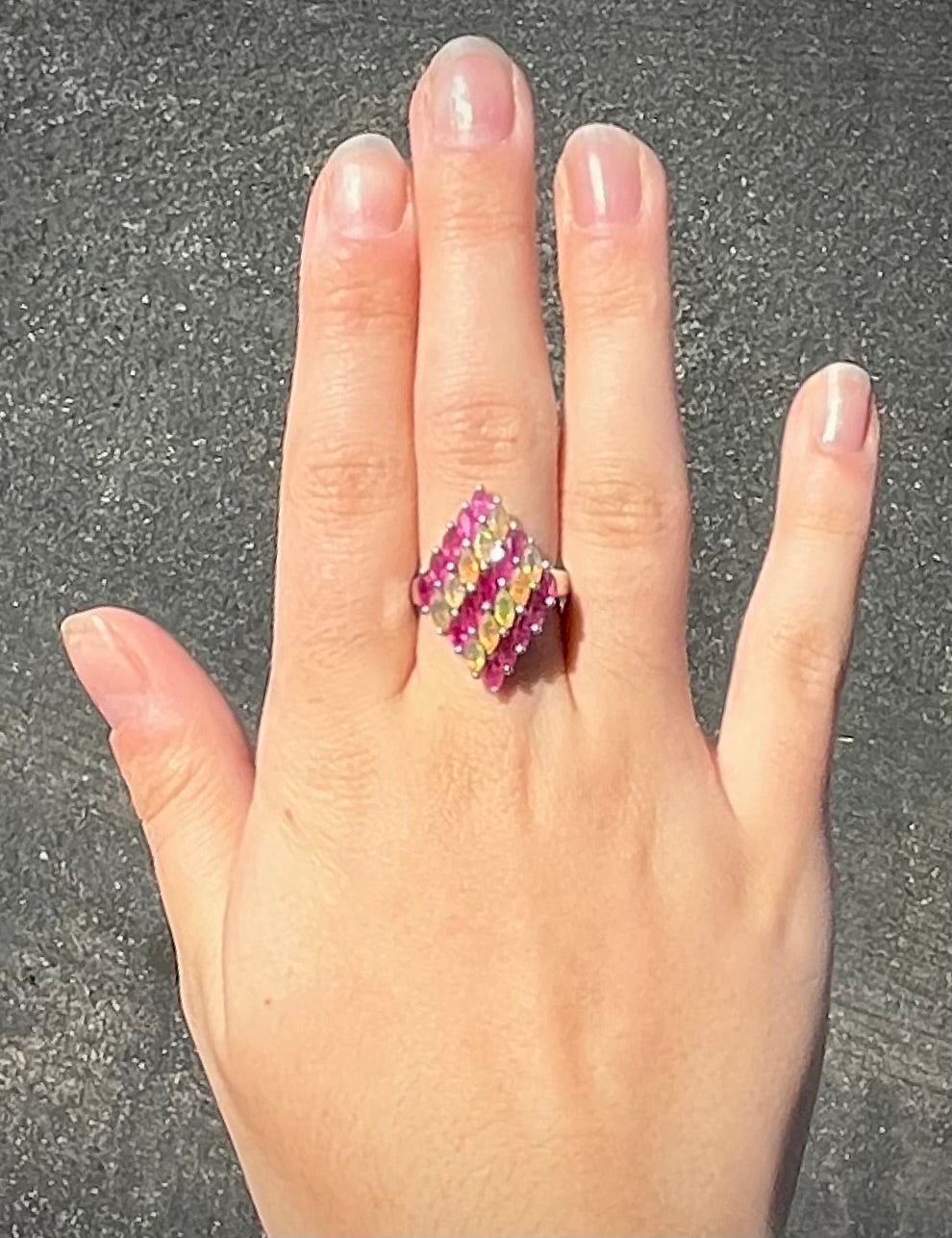 A silver ring set with a cluster of marquise cut rubies and orange Ethiopian fire opals.