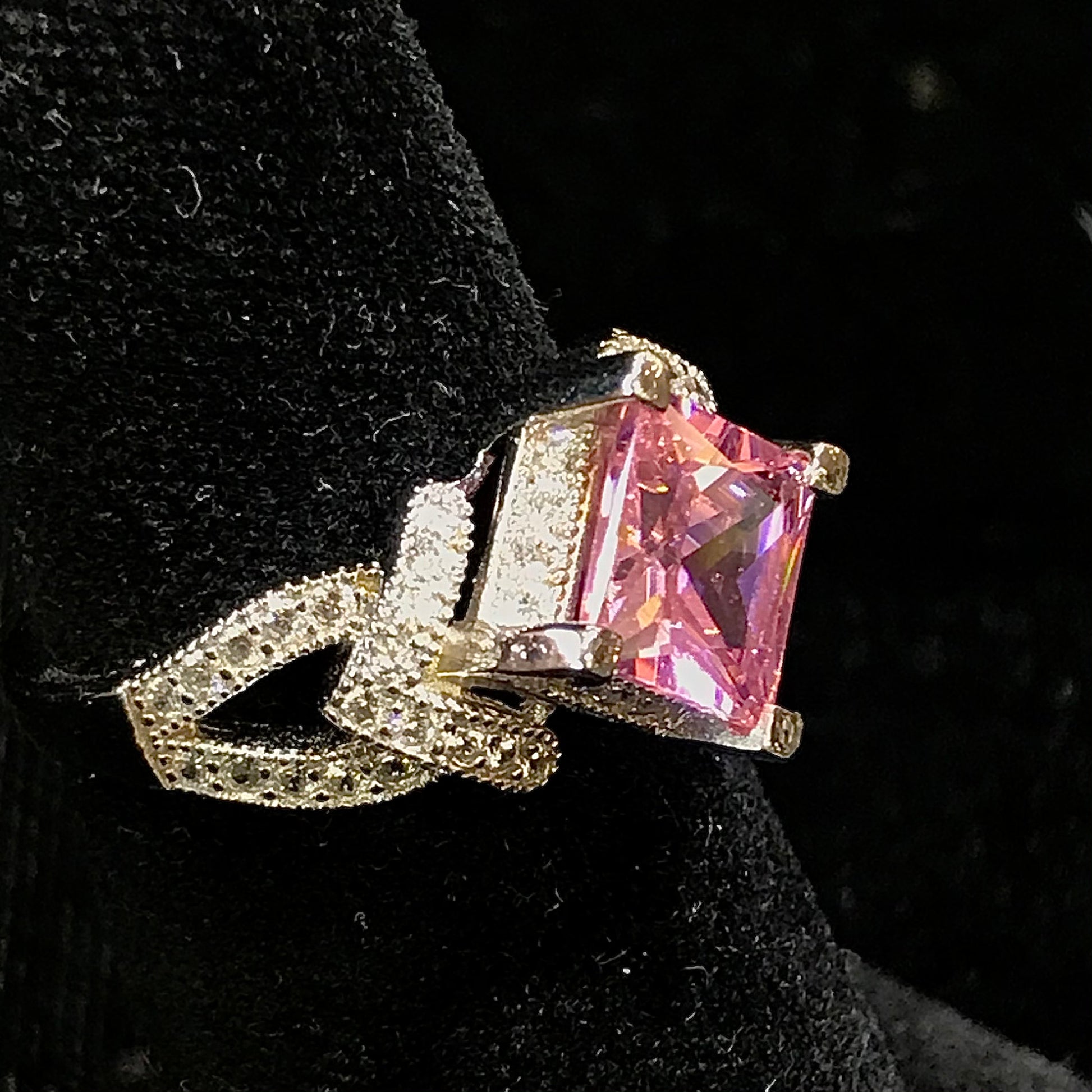 Pink cubic zirconia ring set in sterling silver with white cubic zirconia melee.