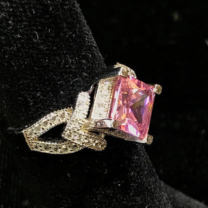 Pink cubic zirconia ring set in sterling silver with white cubic zirconia melee.