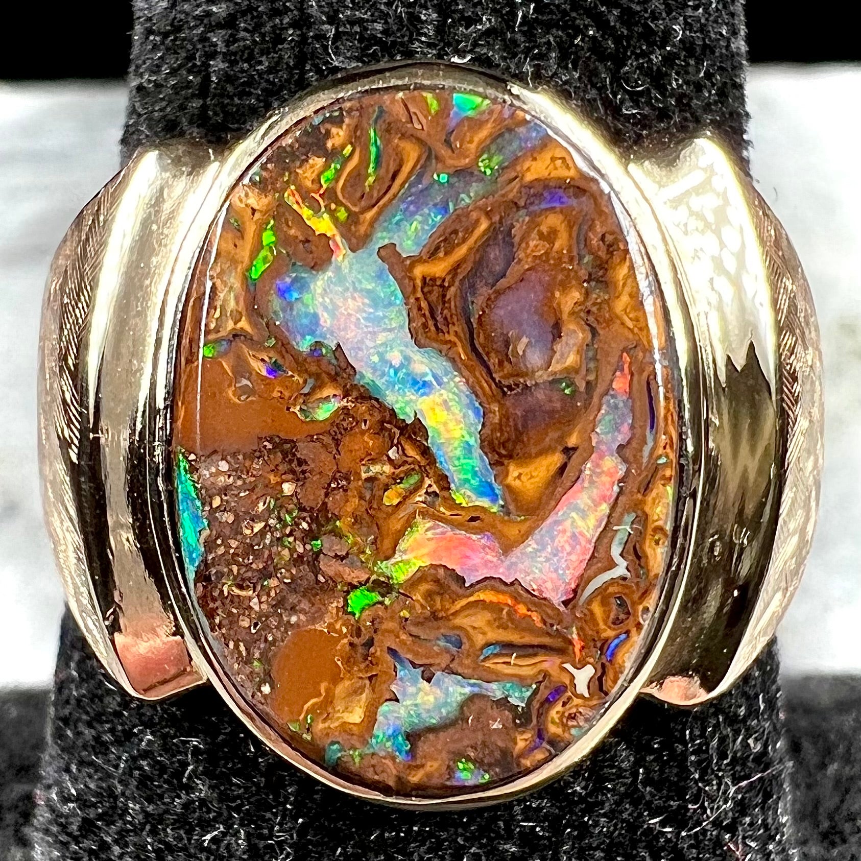 A Koroit boulder opal men's ring in brushed yellow gold.