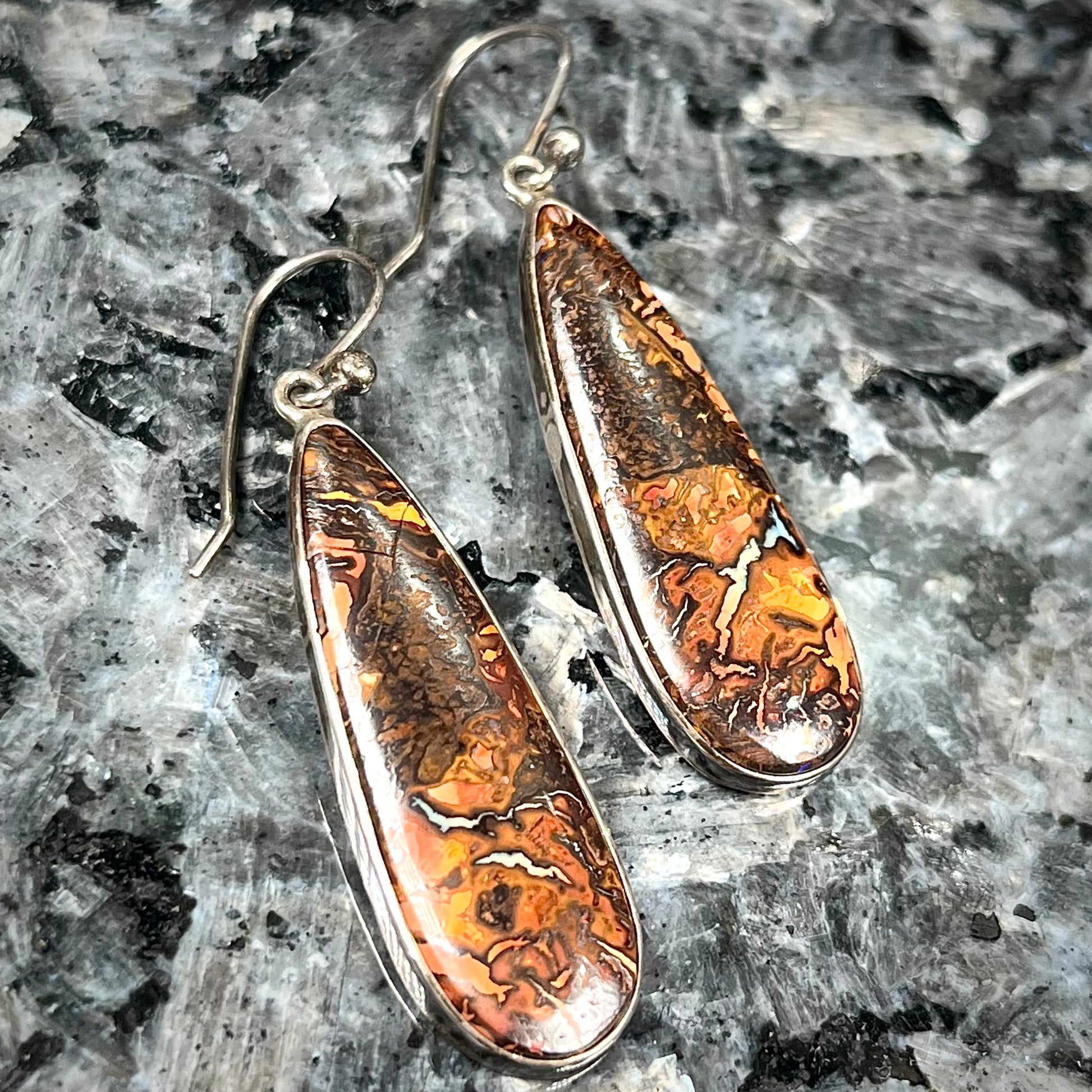 A pair of sterling silver boulder opal drop dangle earrings.