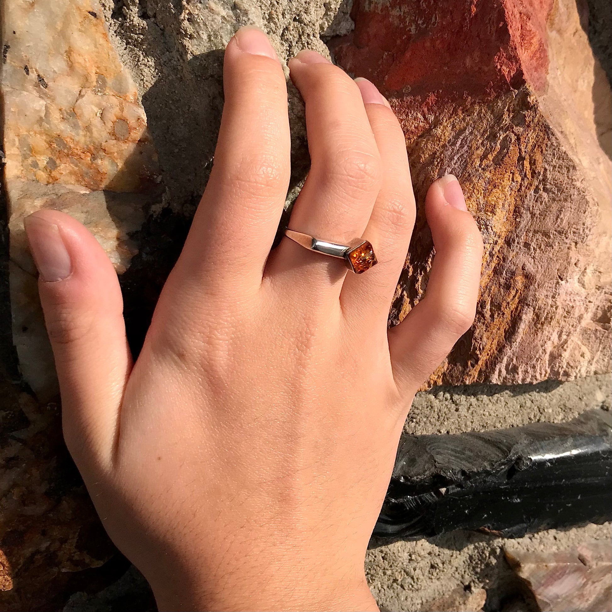 Square shaped Baltic Amber cabochon set in a unique sterling silver ring.