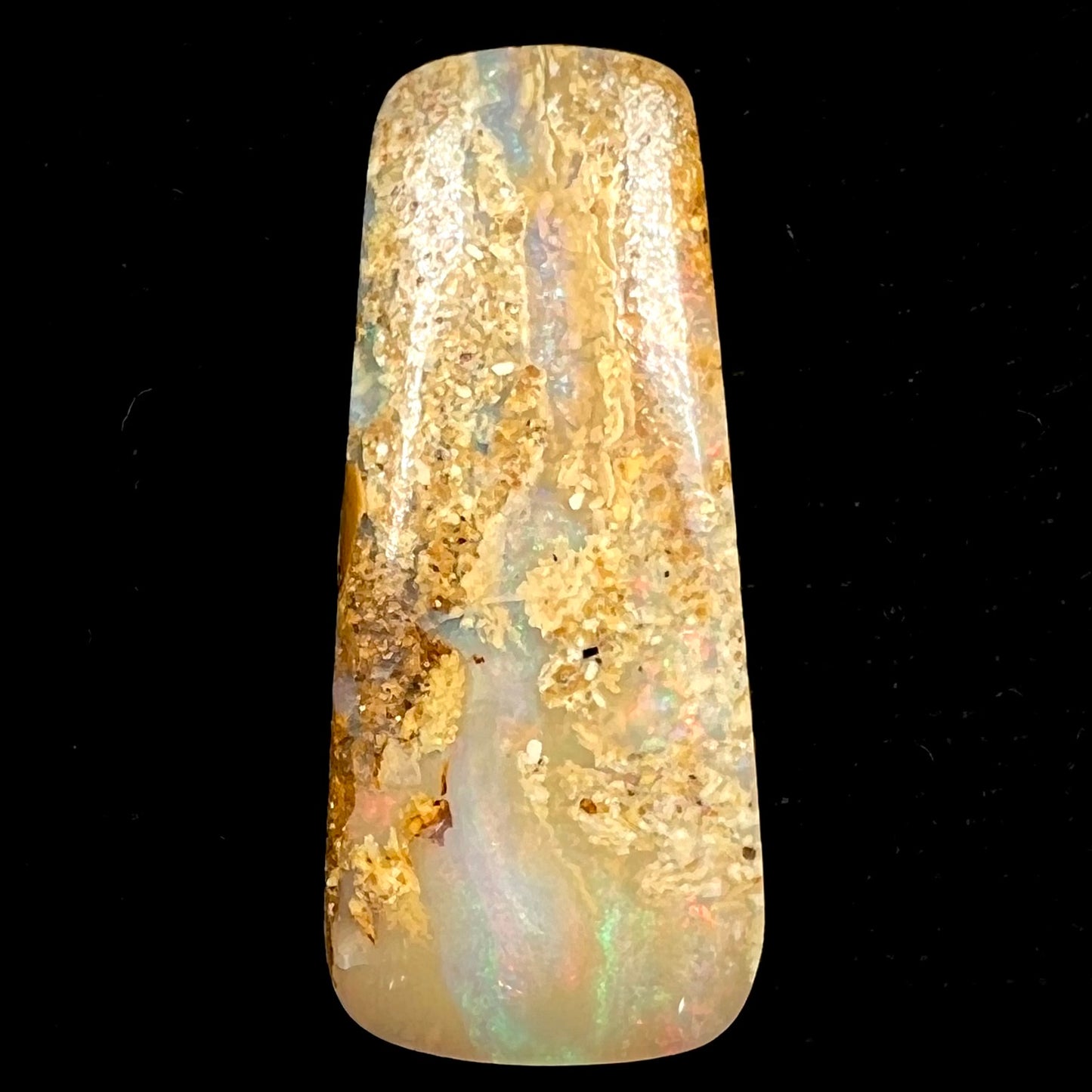 A polished, drilled pipe boulder opal bead.