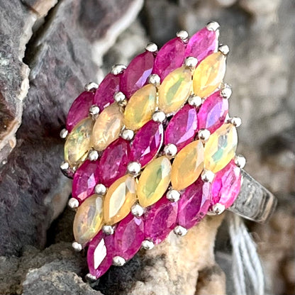 A silver ring set with a cluster of marquise cut rubies and orange Ethiopian fire opals.