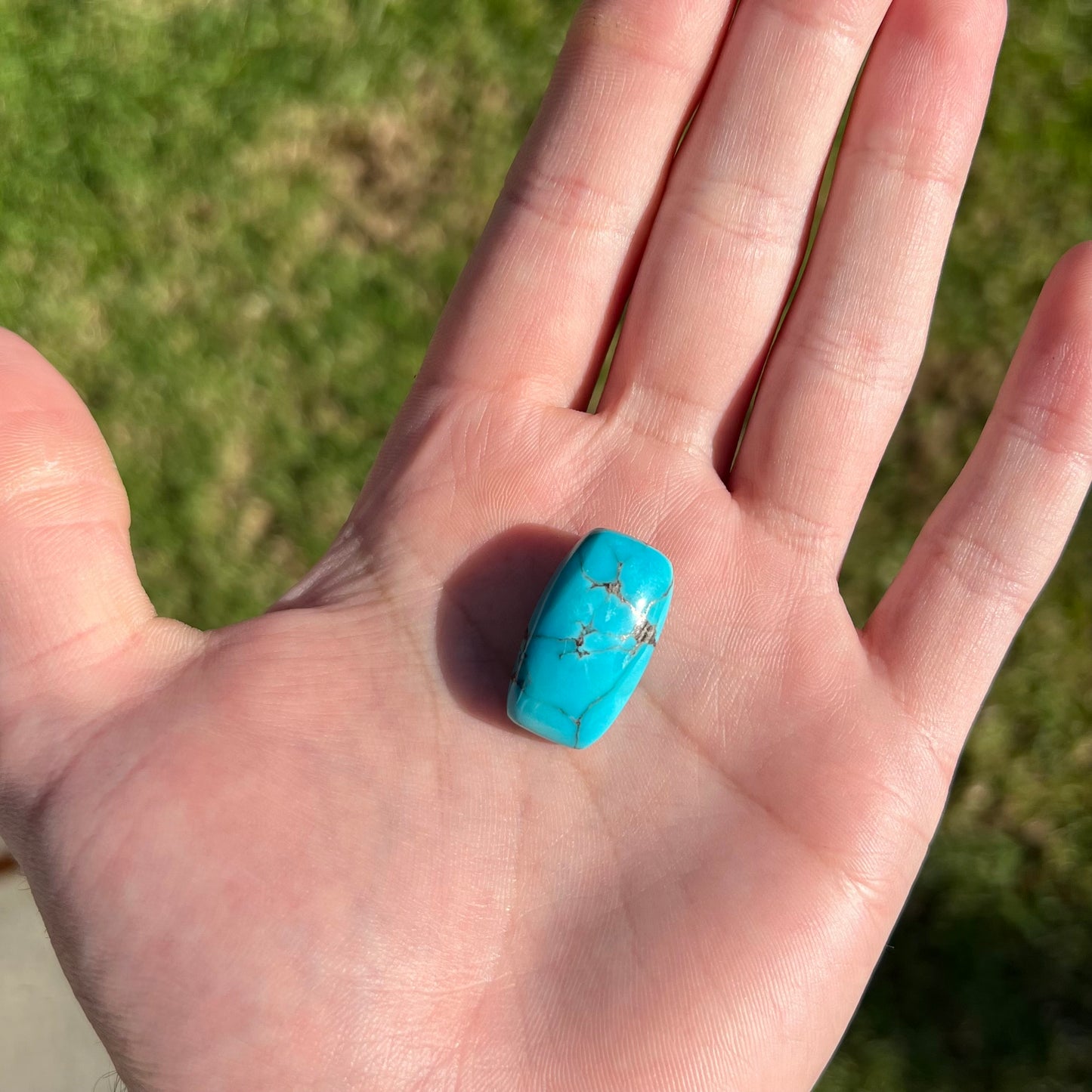A loose, barrel cabochon cut blue turquoise stone from Burro Mountains, New Mexico.
