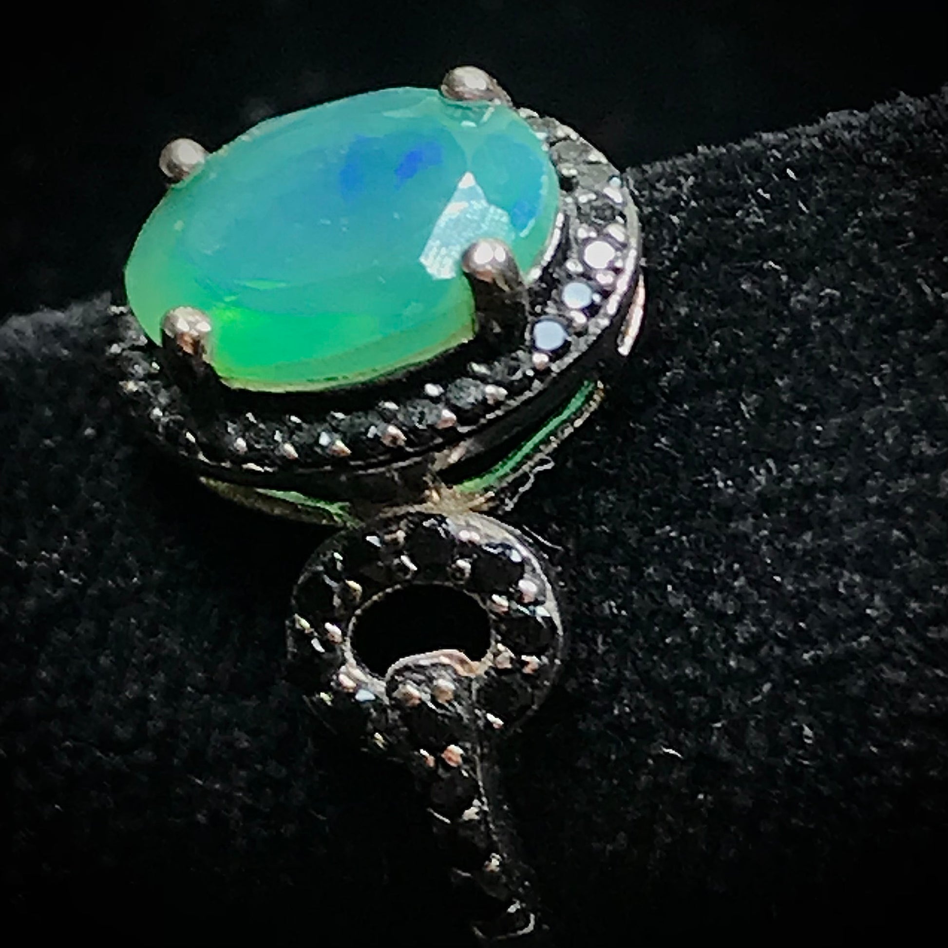 Dyed Ethiopian opal and black spinel prong set into a sterling silver ring.