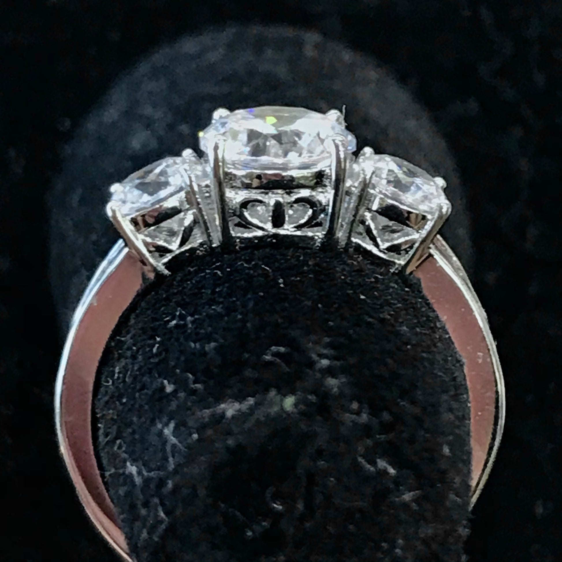 A sterling silver ring set with three round cut cubic zirconia stones.
