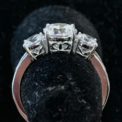 A sterling silver ring set with three round cut cubic zirconia stones.