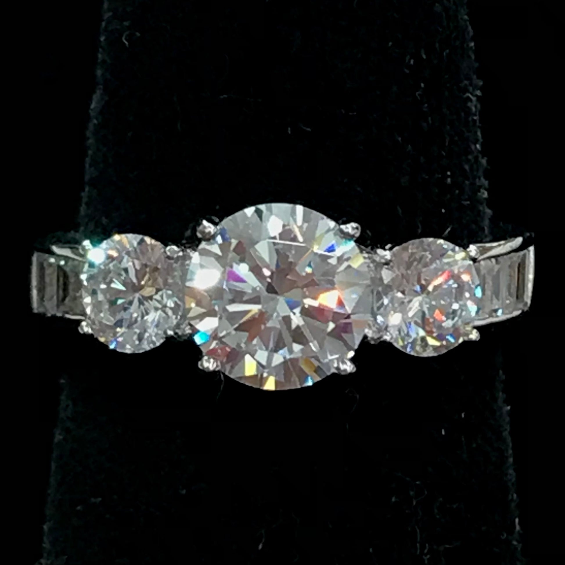 A sterling silver ring set with three round cut cubic zirconia stones.