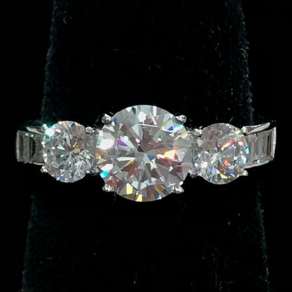 A sterling silver ring set with three round cut cubic zirconia stones.