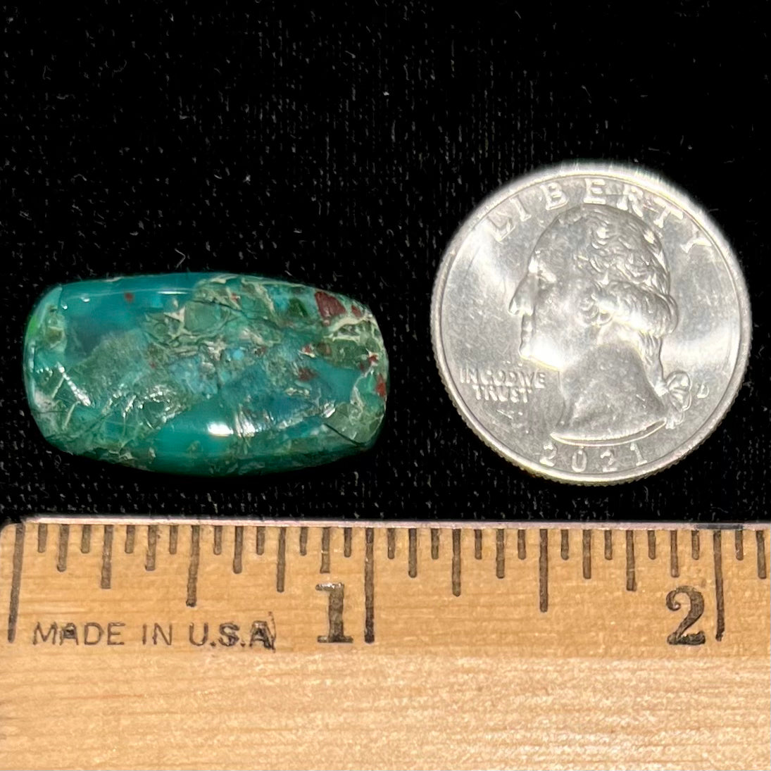 A loose, green, barrel cabochon shaped chrysocolla stone from Morenci, Arizona.
