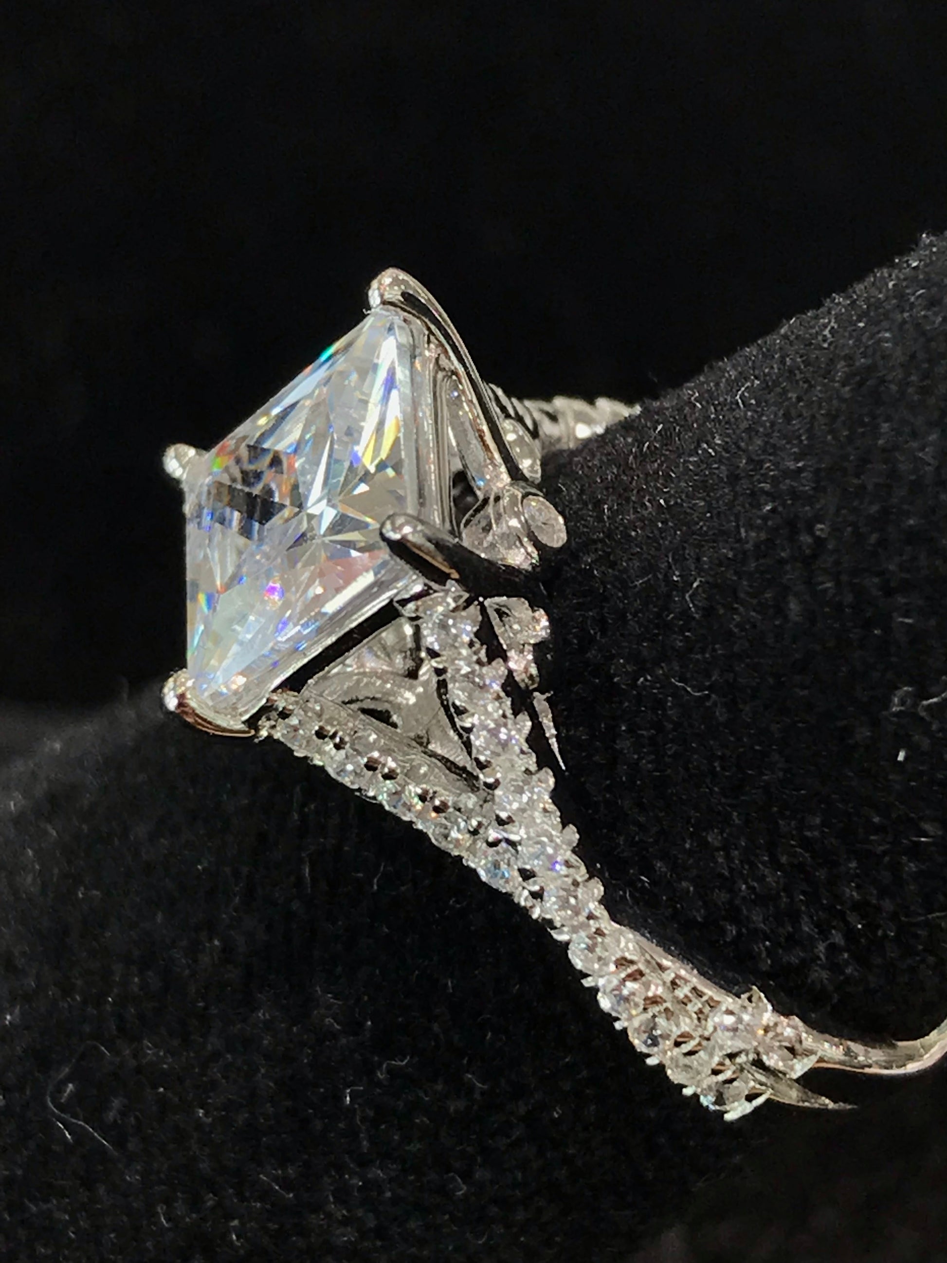 Women's cubic zirconia princess cut ring set in sterling silver with a twisted shank.
