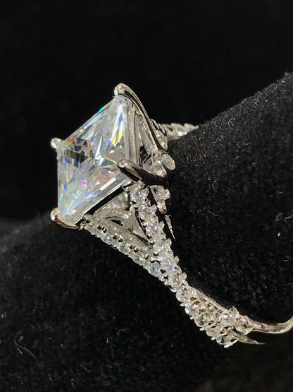 Women's cubic zirconia princess cut ring set in sterling silver with a twisted shank.