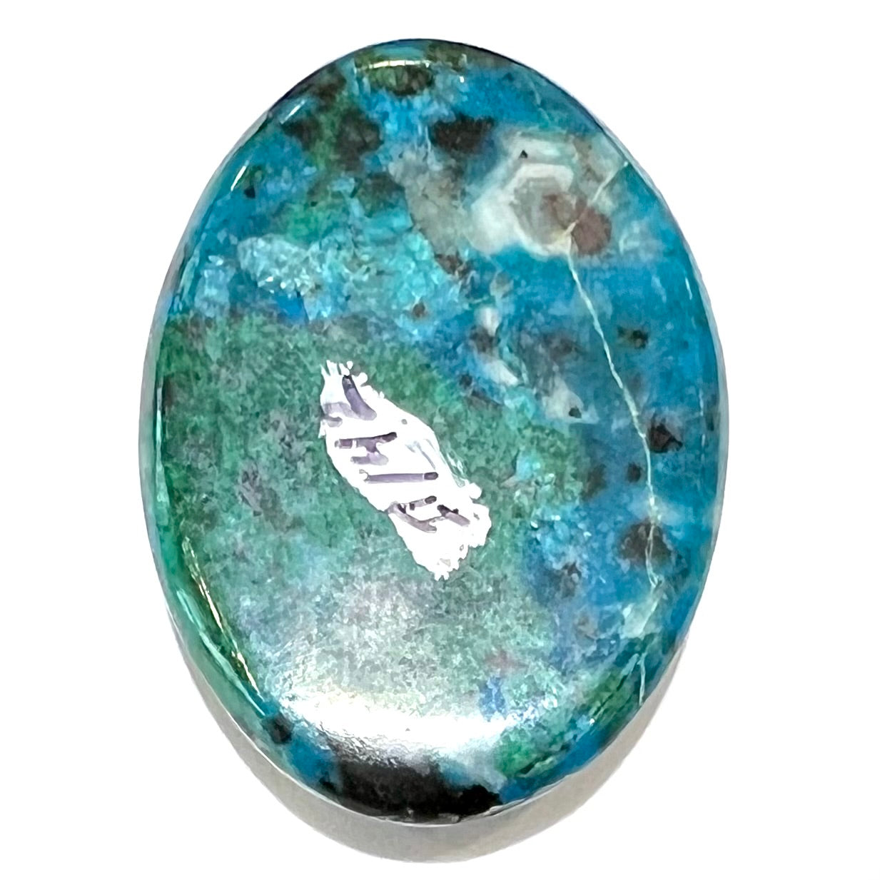 An oval cabochon cut blue chrysocolla with green malachite inclusions.