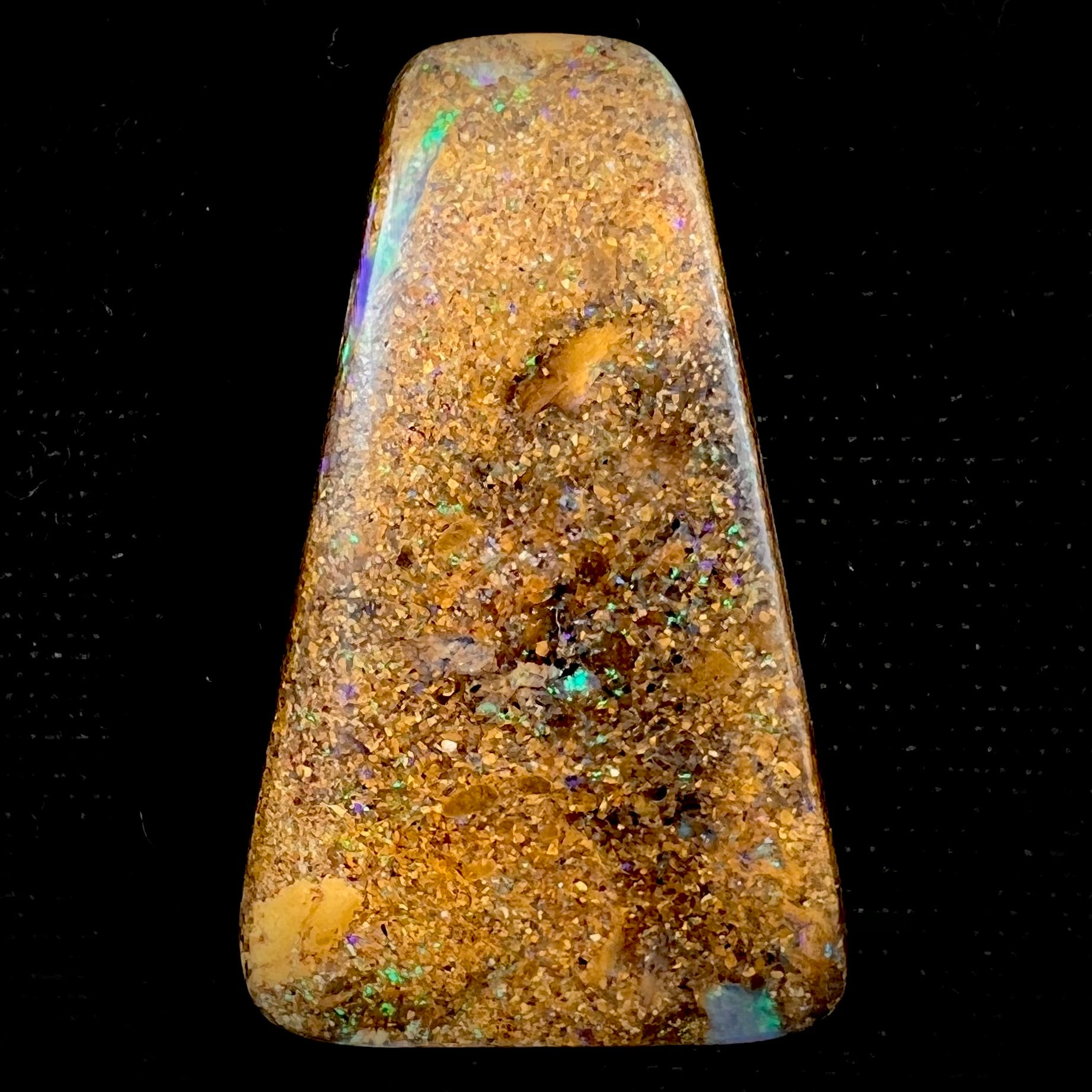 A polished, drilled pipe boulder opal bead.