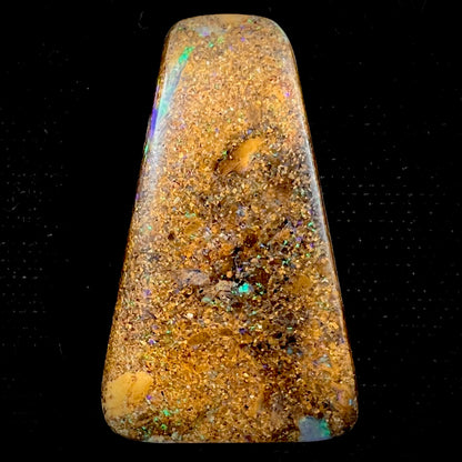 A polished, drilled pipe boulder opal bead.