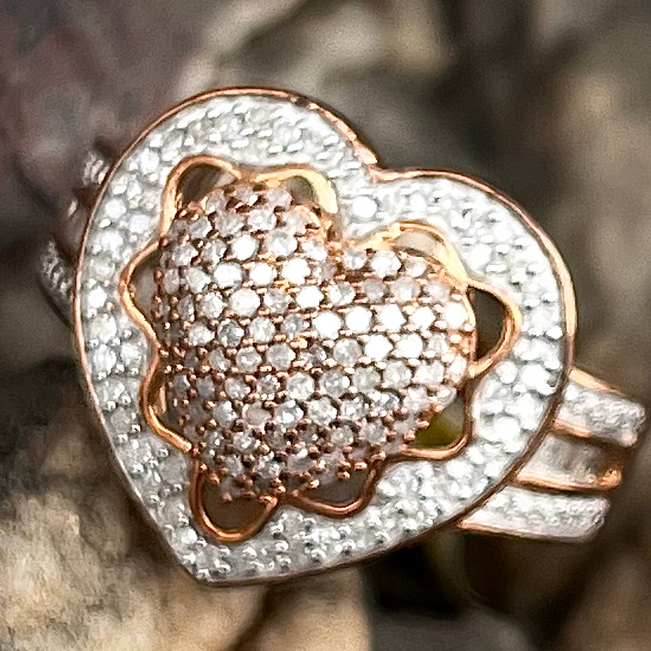 A rose colored metal ring pavé set with round and baguette cut diamonds.