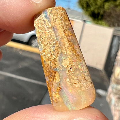 A polished, drilled pipe boulder opal bead.