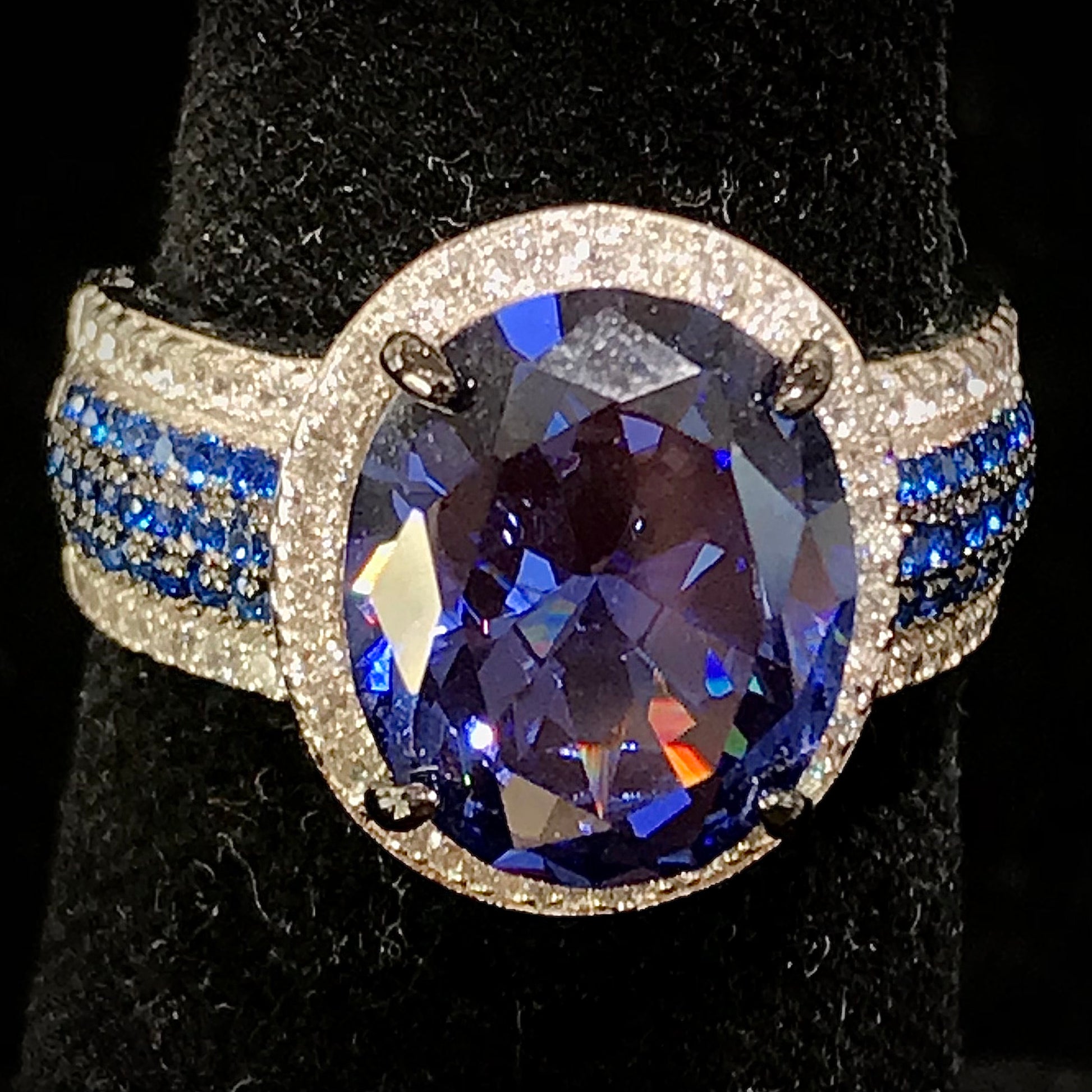 Synthetic blue and white gemstone ring prong set in sterling silver.