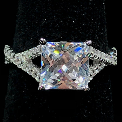 Women's cubic zirconia princess cut ring set in sterling silver with a twisted shank.