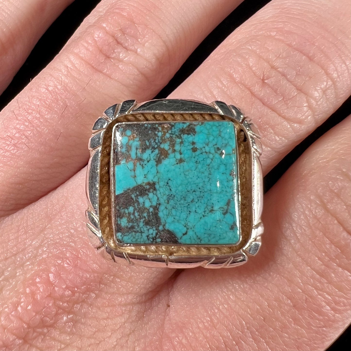 A handmade sterling silver, unisex, likely Navajo ring set with Tibetan turquoise.