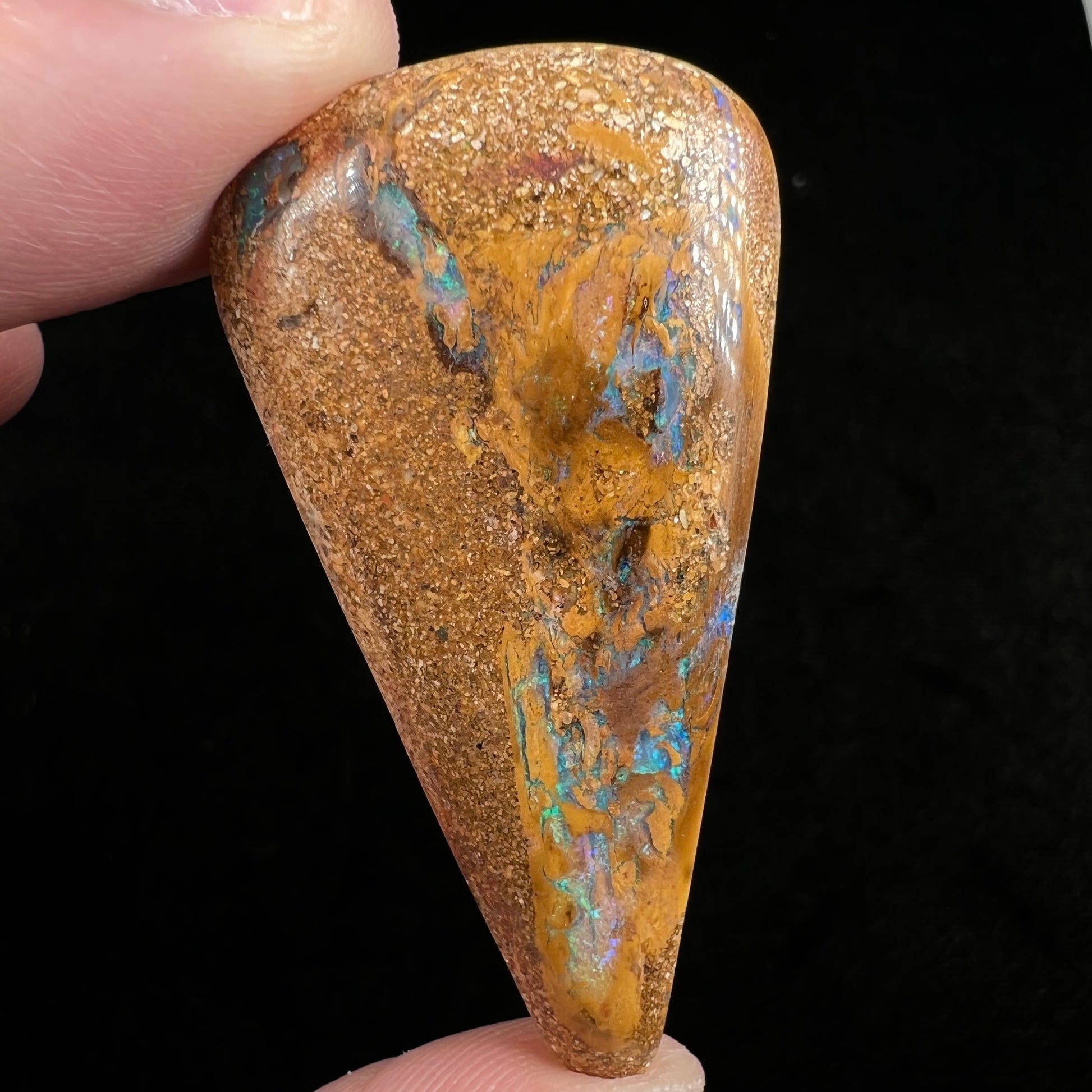 A polished, drilled pipe boulder opal bead.