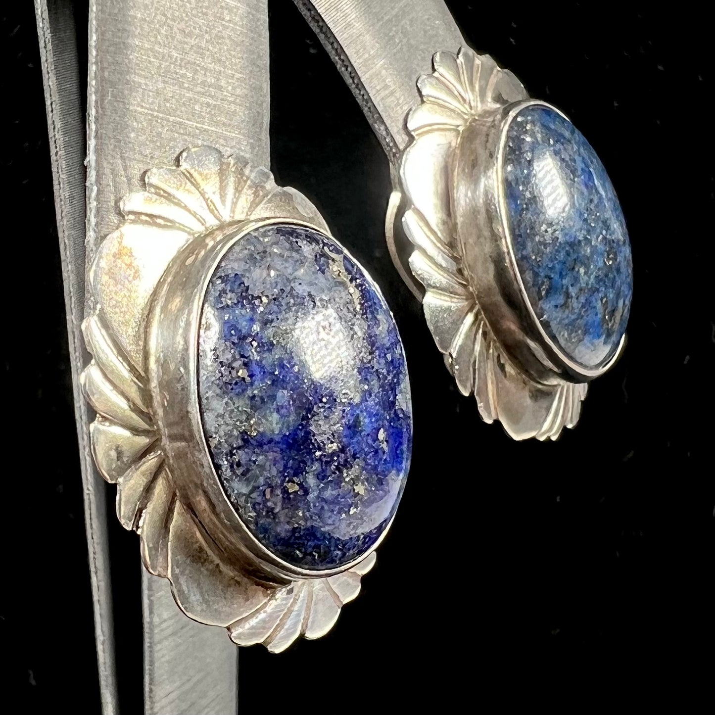 A pair of sterling silver lapis lazuli earrings handmade by Navajo artist, Filbert Brown.