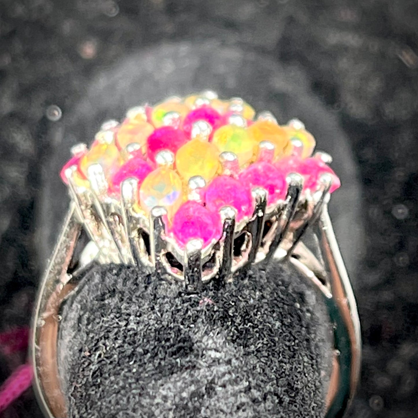 A silver ring set with a cluster of marquise cut rubies and orange Ethiopian fire opals.