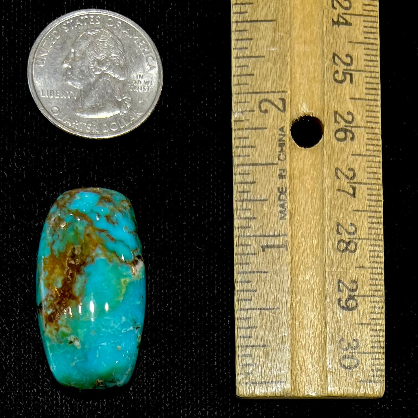 A loose, polished cabochon cut turquoise stone from Royston Mining District, Nevada.