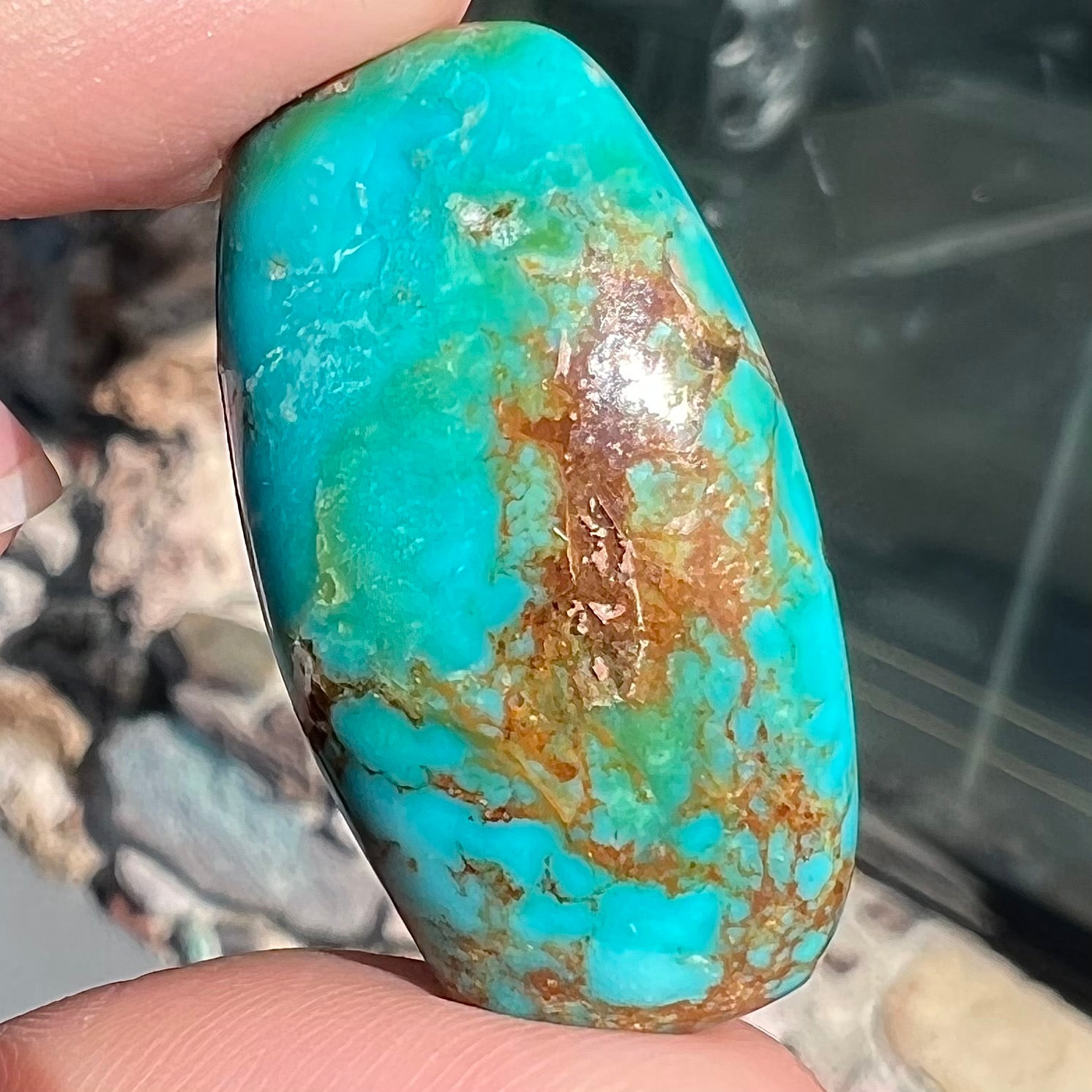A loose, polished cabochon cut turquoise stone from Royston Mining District, Nevada.