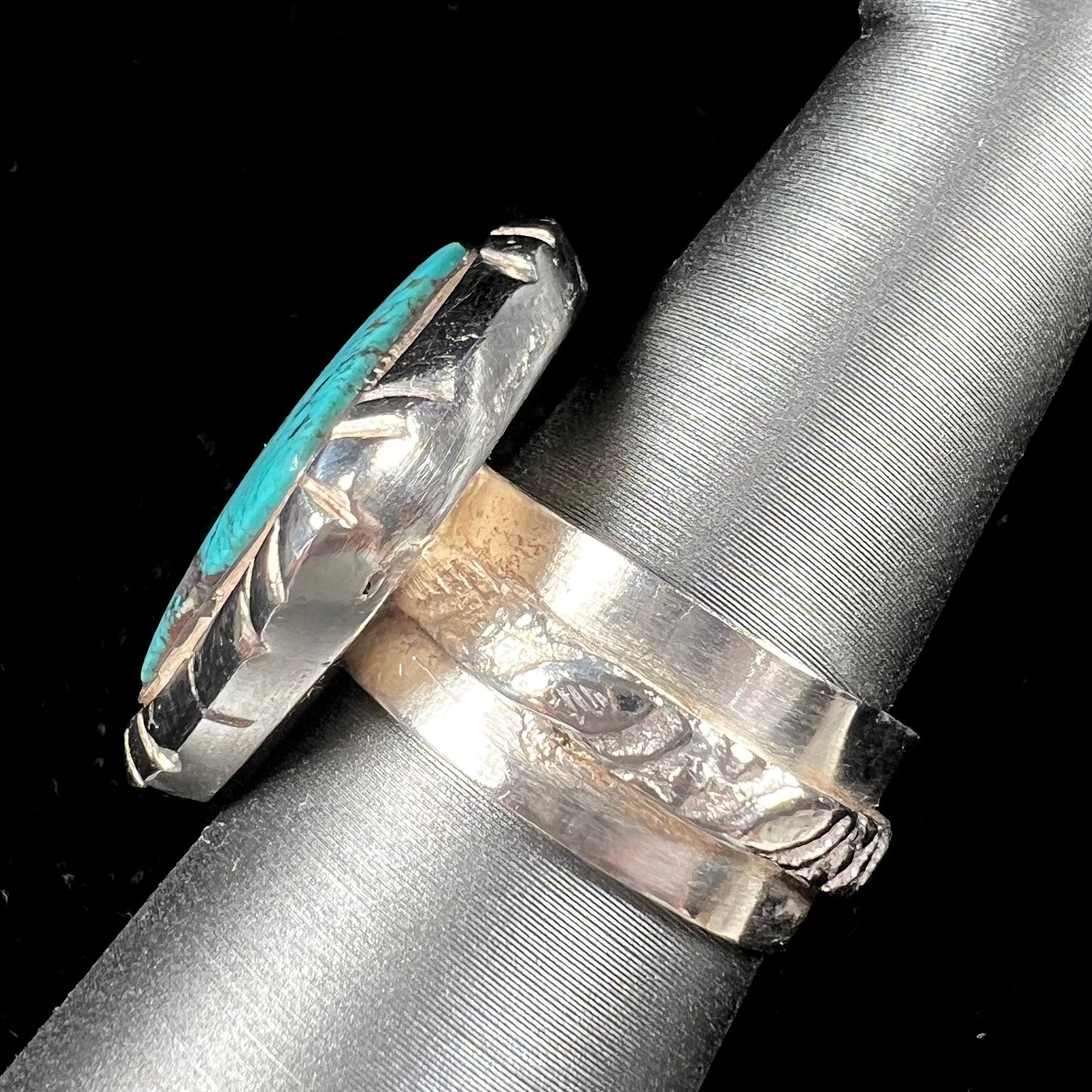 A handmade sterling silver, unisex, likely Navajo ring set with Tibetan turquoise.